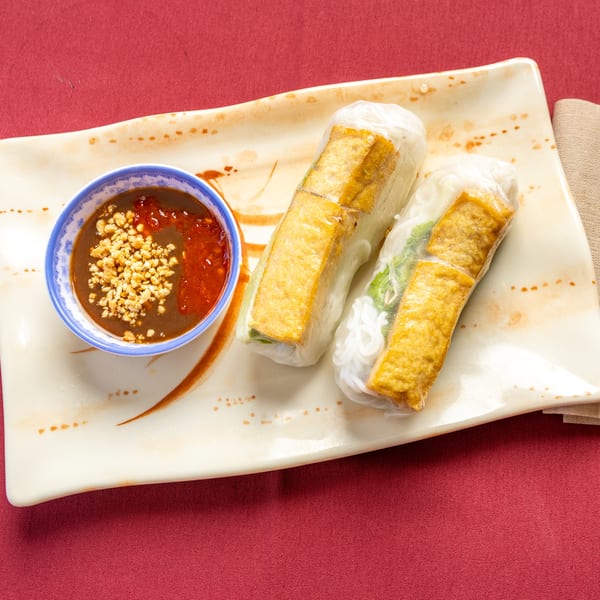 Two fresh spring rolls with fried tofu and vermicelli, served with peanut dipping sauce.