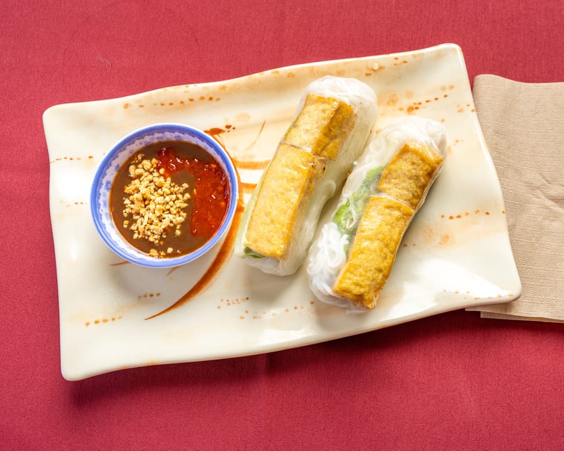 Two fresh spring rolls with fried tofu and vermicelli, served with peanut dipping sauce.